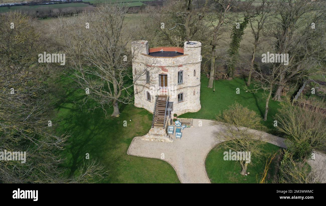 A drone shot of Dinton castle (Dinton Folly) with its precinct on a gloomy day Stock Photo