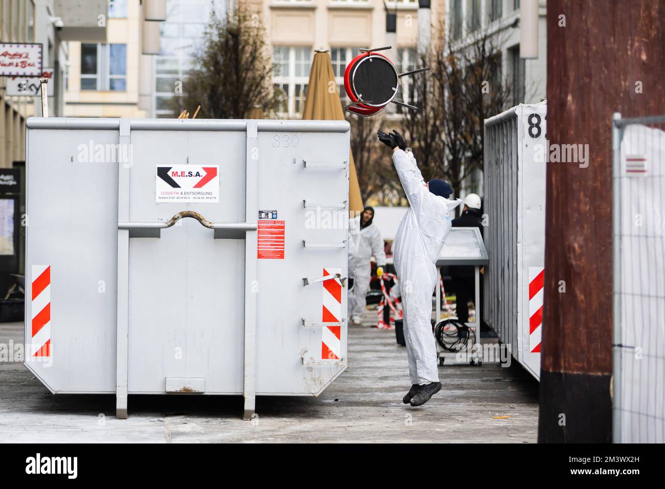 Berlin, Germany. 17th Dec, 2022. A worker throws a chair into a