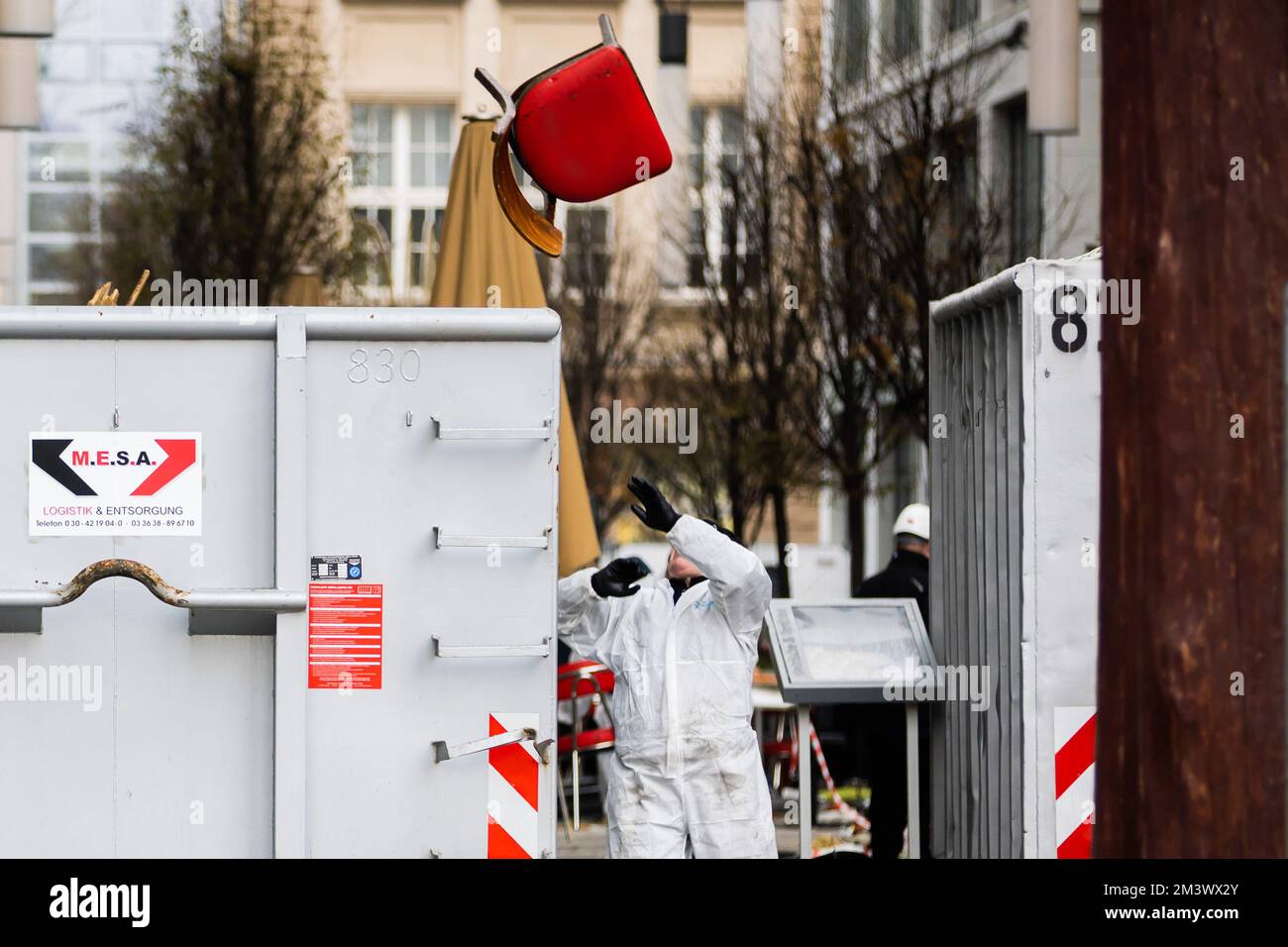 Berlin, Germany. 17th Dec, 2022. A worker throws a chair into a