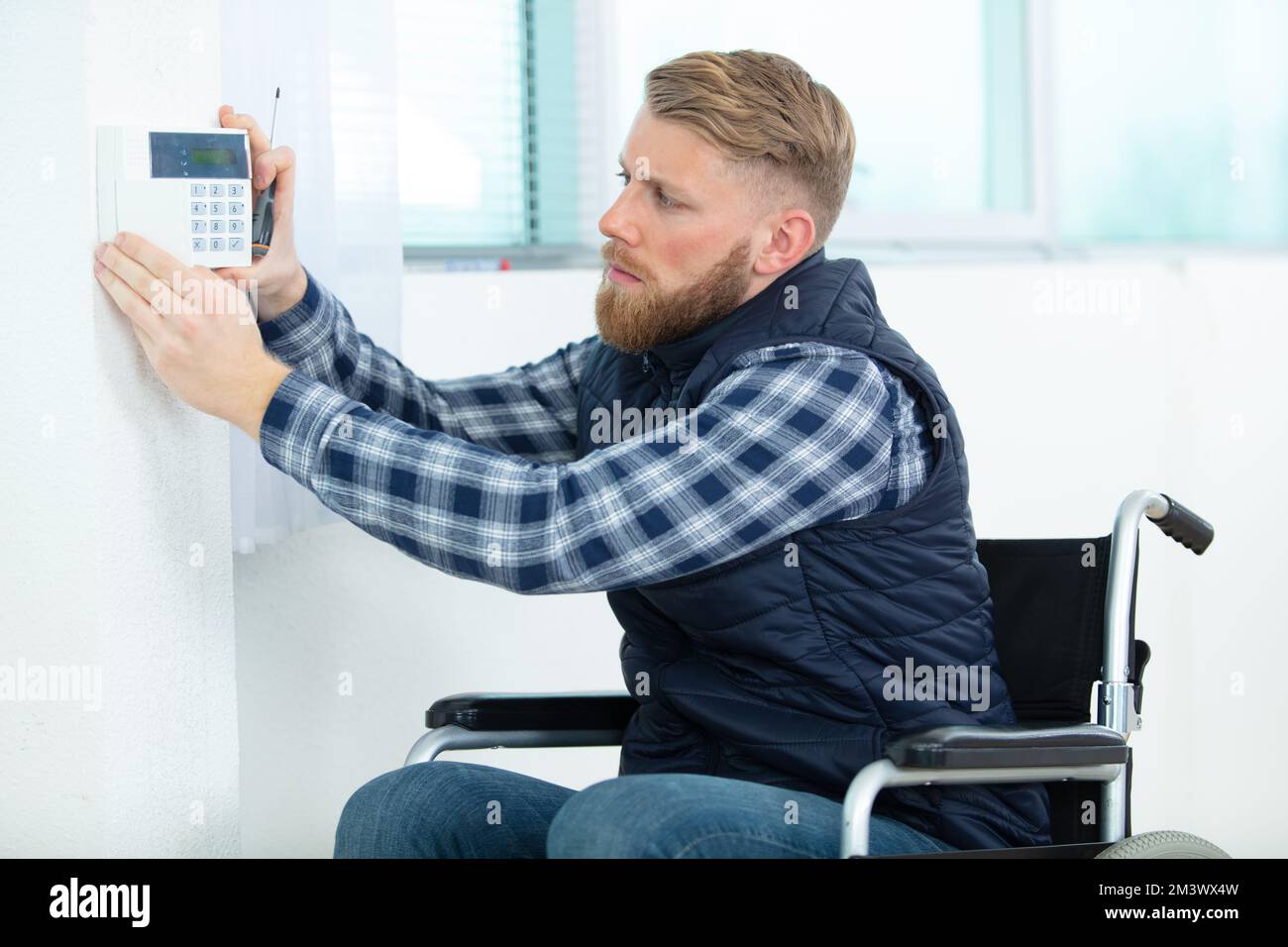 engineer repairman on wheelchair working Stock Photo Alamy