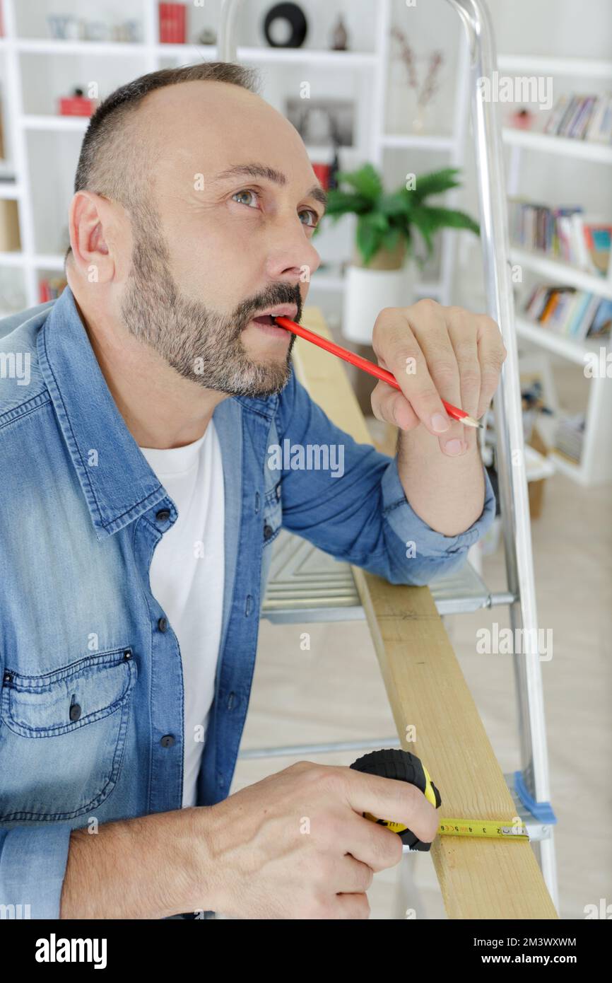 man is thinking about something with pencil Stock Photo