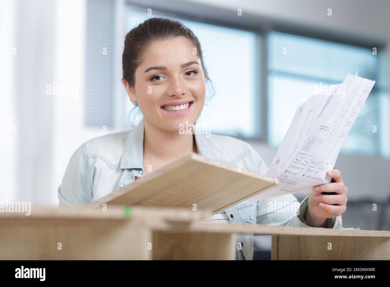 young girl arranging apartment house interior Stock Photo Alamy