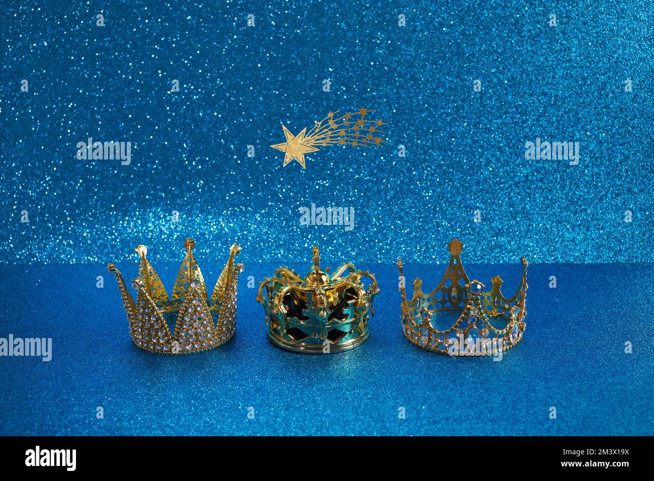 Three crowns of the three wise men with star over blue background. For Reyes Magos day and Happy Epiphany day Stock Photo