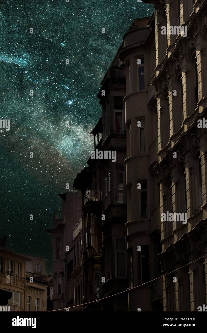 Photograph of a historical street and milky way galaxy in Istanbul Beyoglu. Long exposure night, starry sky image. Vertical photo with noise and grain Stock Photo