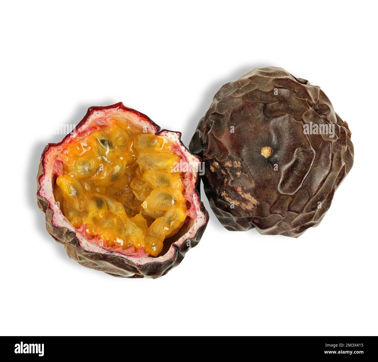 a dried passion fruit cut in half on a white background Stock Photo Alamy