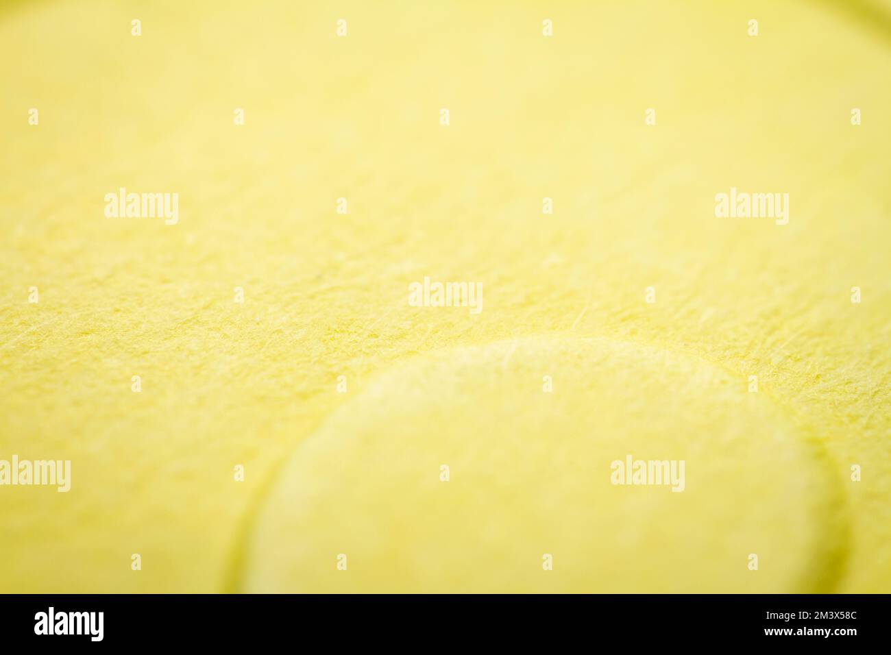 Extreme macro of embossed yellow paper. Selective focus, shallow depth of field. Stock Photo