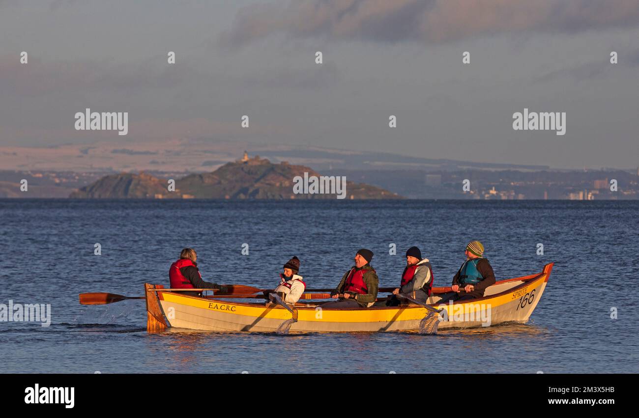 Firth of Forth, Portobello, Edinburgh, Scotland, UK. 17th December 2022. Colourful happy crews putting their backs into it on the Eastern Amateur Coastal Rowing Boats this morning with Inchkeith island in background. Temperature at a chilly 4 degrees centigrade. Credit: ArchWhite/alamy live news. Stock Photo