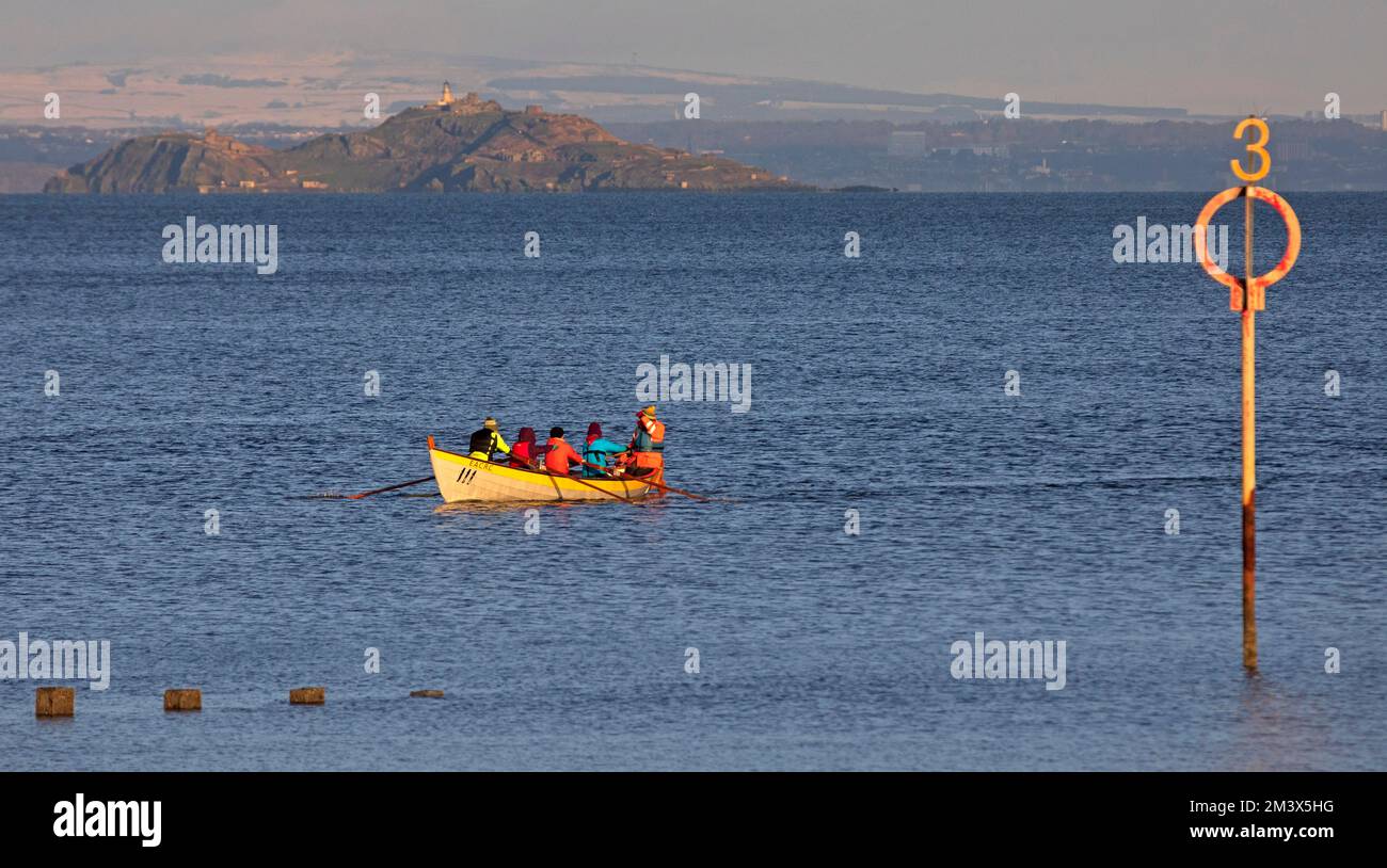 Firth of Forth, Portobello, Edinburgh, Scotland, UK. 17th December 2022. Colourful happy crews putting their backs into it on the Eastern Amateur Coastal Rowing Boats this morning with Inchkeith island in background. Temperature at a chilly 4 degrees centigrade. Credit: ArchWhite/alamy live news. Stock Photo