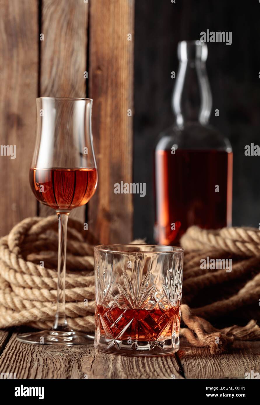 Crystal glass, snifter, and bottle with rum, cognac, or whiskey on an