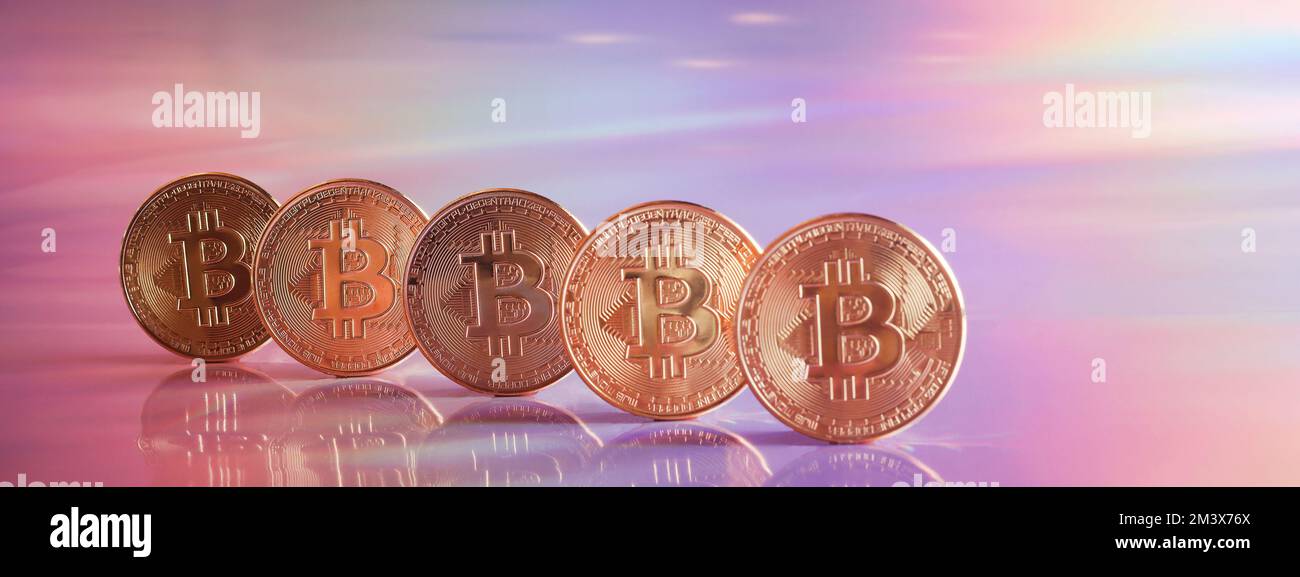 Golden bitcoin coins on holographic, abstract, neon background. digital currency, business style. Mining and trade bitcoin concept. banner copy space Stock Photo
