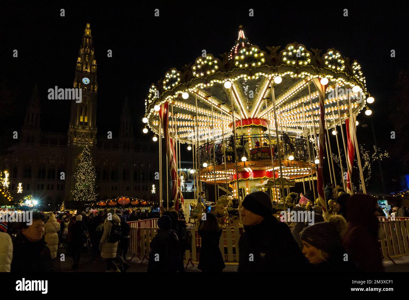 Traditional merry-go-round at Wiener Christkindlmarkt, Rathaus Platz (City Hall Square), Vienna, Austria Stock Photo