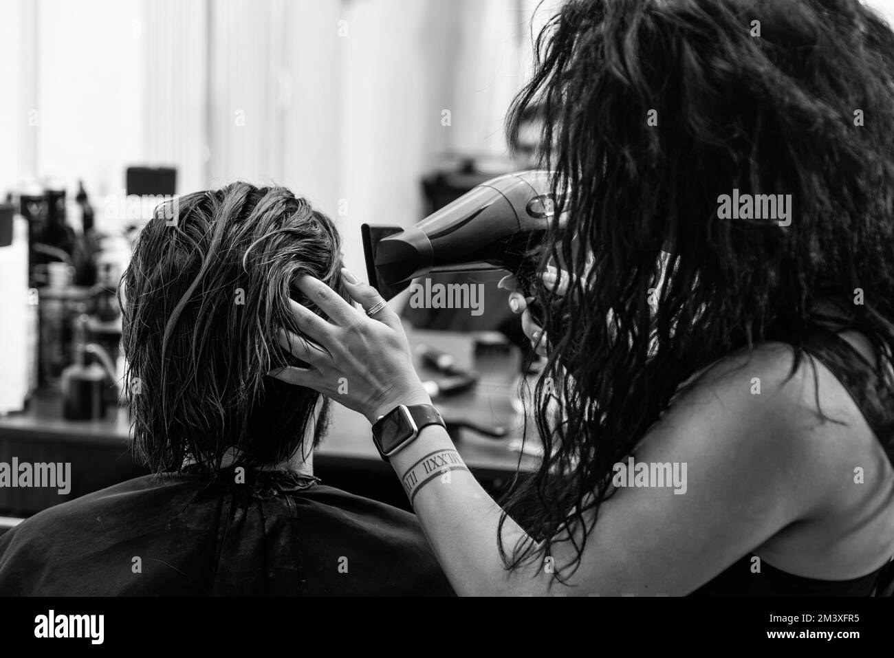 dry hair. making new hairstyle. female hairdresser in bearded