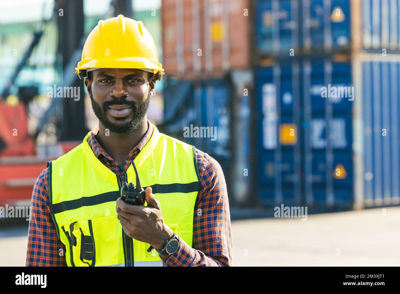 portrait African black male engineer staff worker foreman at container yard control loading cargo Stock Photo