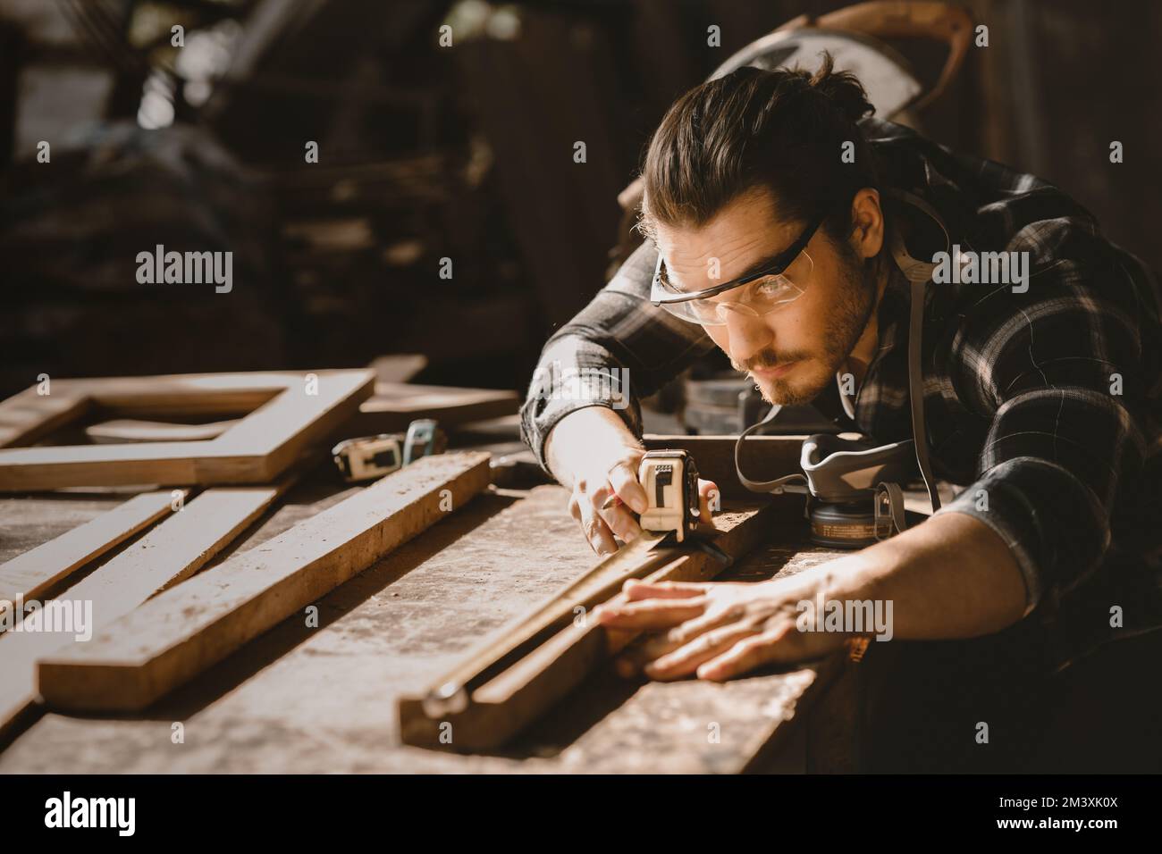 carpenter man furniture artisan handcrafted making woodwork at wood workshop Stock Photo