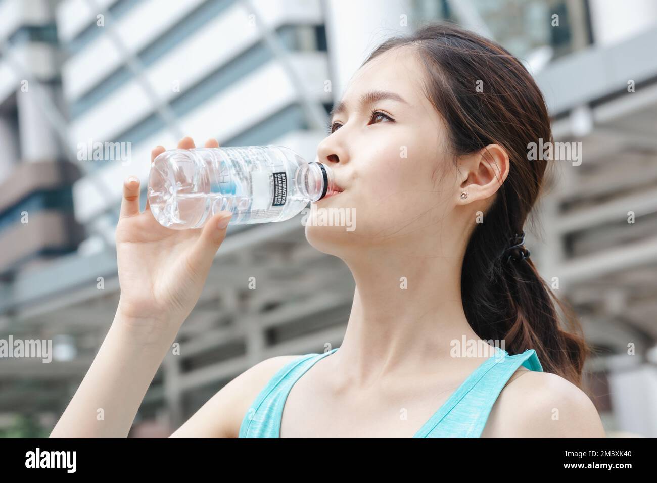 Teenage girl drinks water from bottle Stock Photo by ©BestPhotoStudio  64410247
