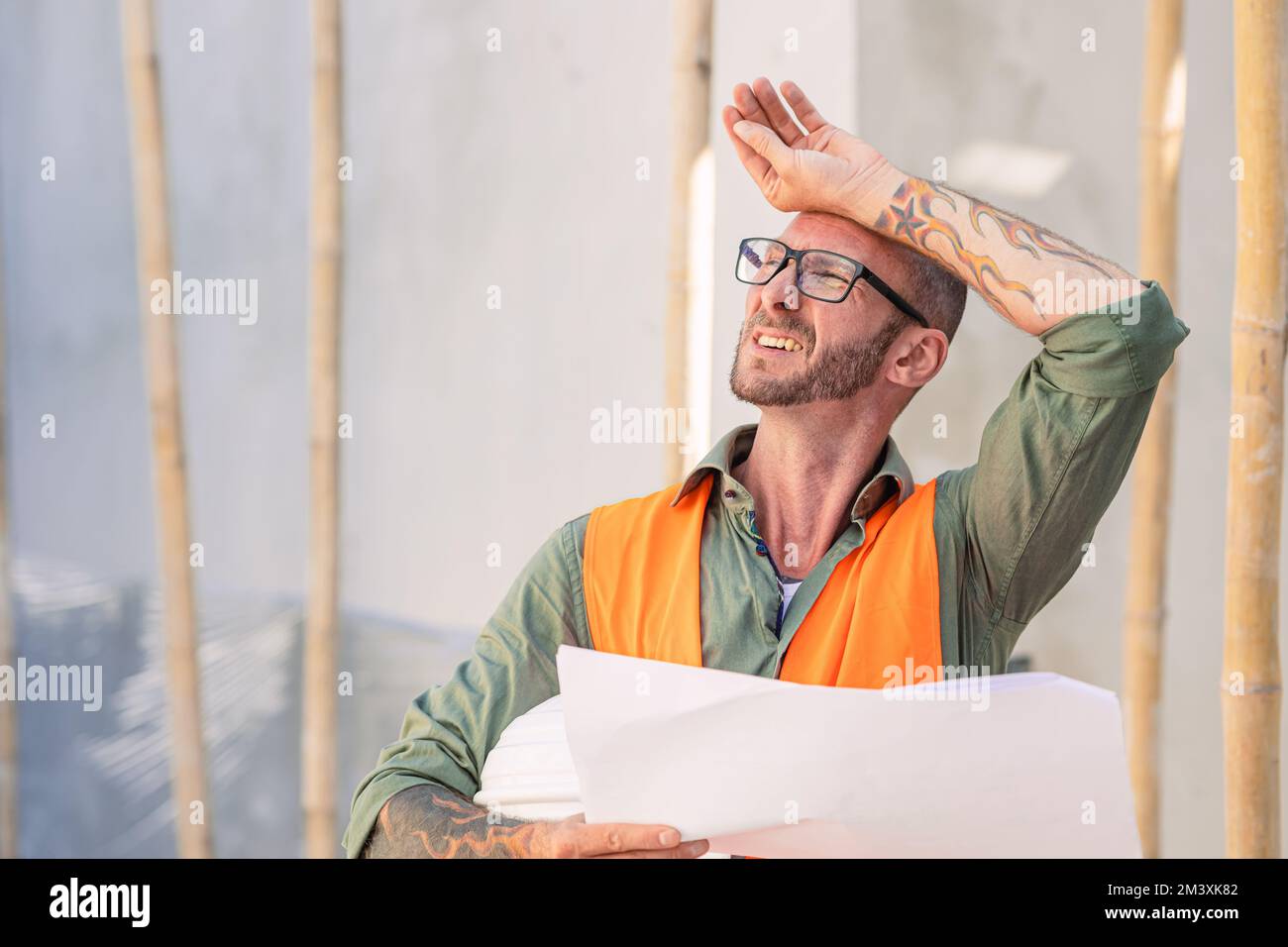 Tired builder fatigue worker from hard working hot weather summer high UV sun sweat Stock Photo