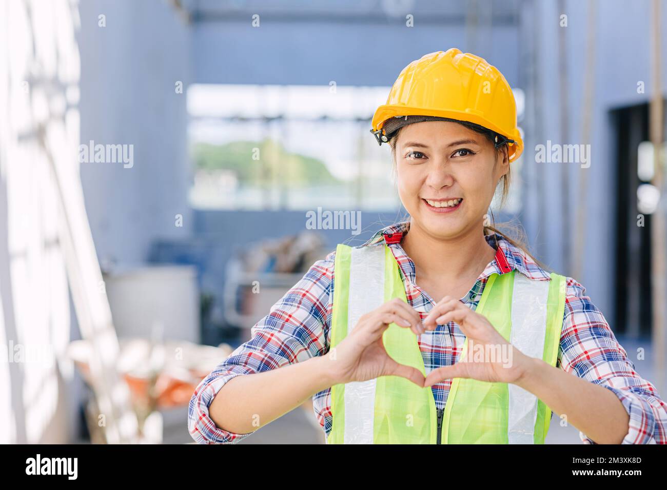 Architect engineer foreman builder foreman construction worker happy smile hand love heart sign Stock Photo