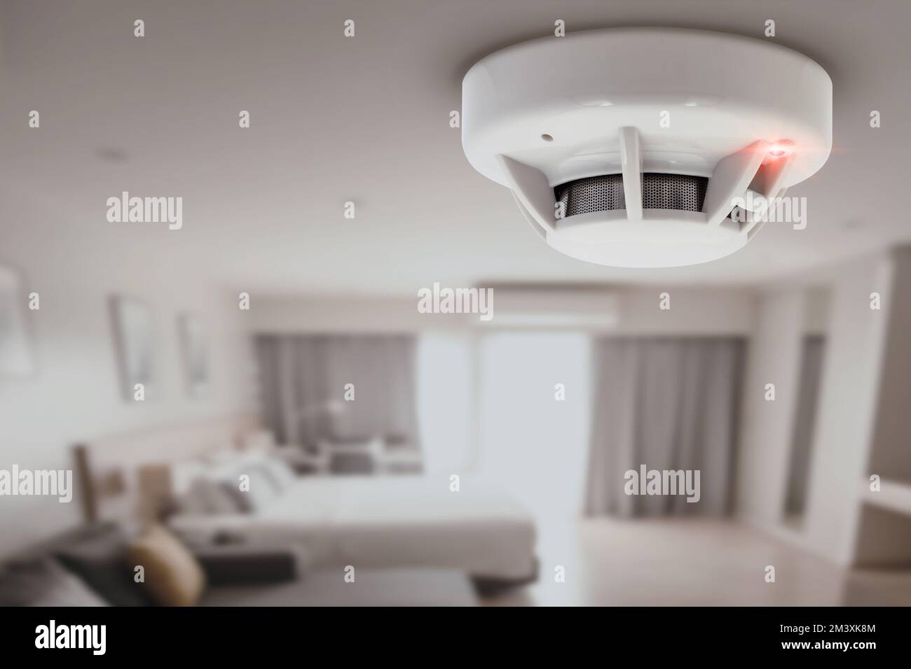 smoke detector fire alarm detector home safety device setup at home hotel room ceiling Stock Photo