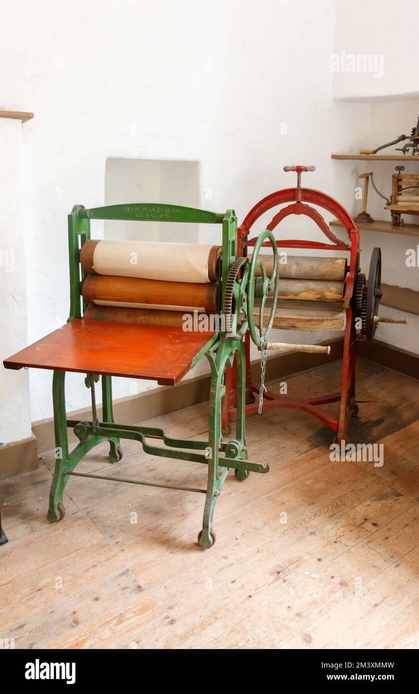 vintage laundry mangles in old English house washroom or scullery  Killerton House National trust property Stock Photo