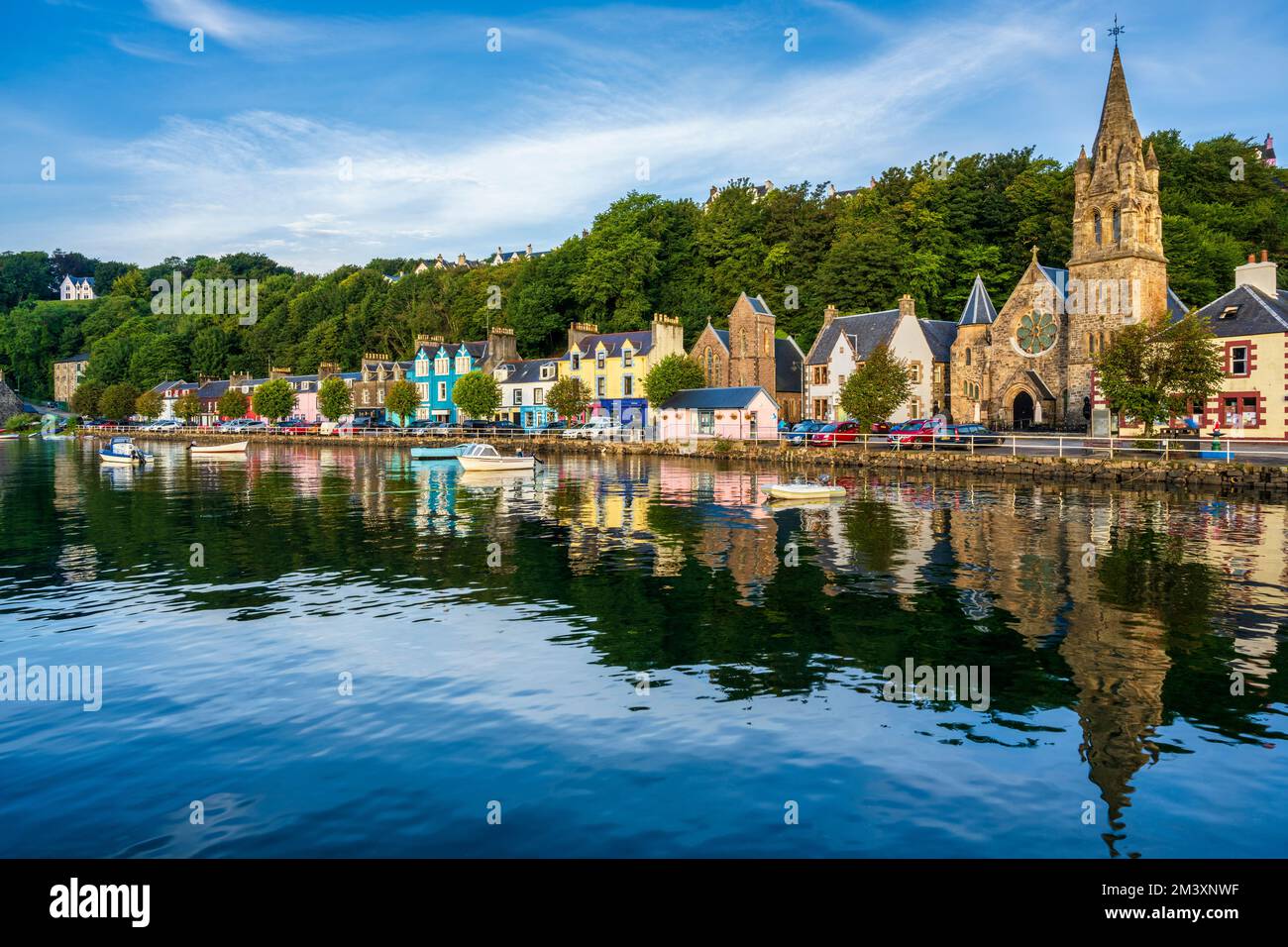 Early morning light and colourful reflections of houses on Main Street in Tobermory, Isle of Mull, Scotland, UK Stock Photo