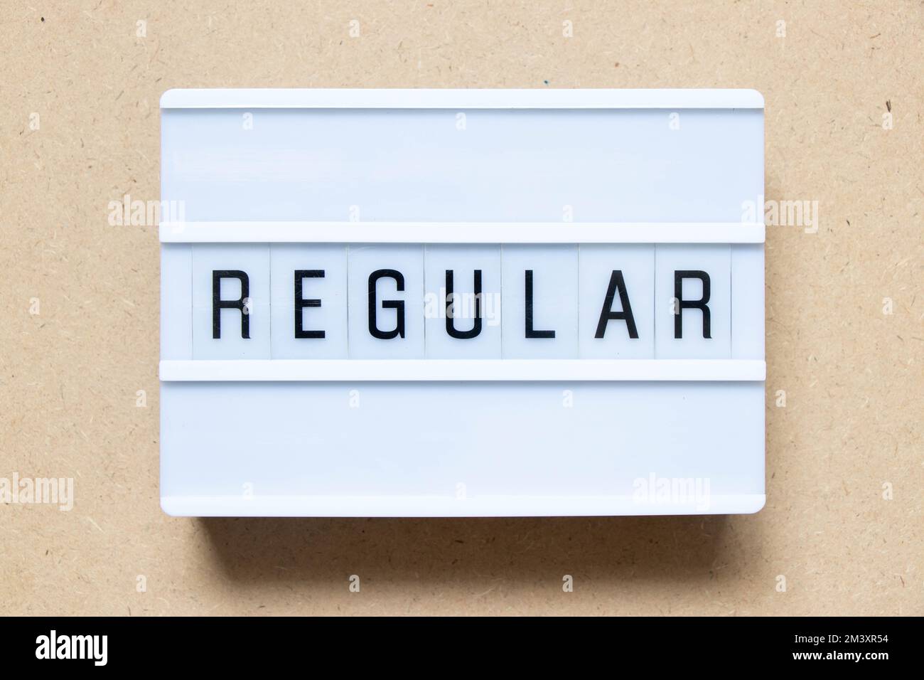 Lightbox with word regular on wood background Stock Photo