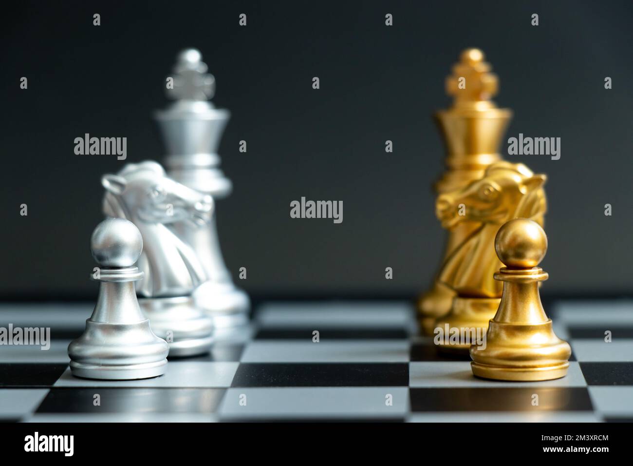Gold pawn, horse knight and king in chess game face with the another