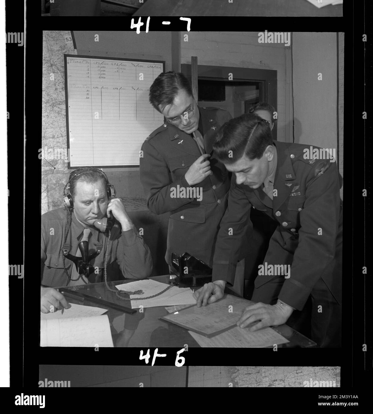 Operations officers and controllers around communications table in ops. room, Toni Frissell, Antoinette Frissell Bacon, Antoinette Frissell Stock Photo