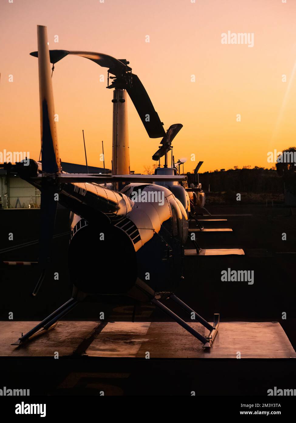 Helicopters lined up at sunset Stock Photo