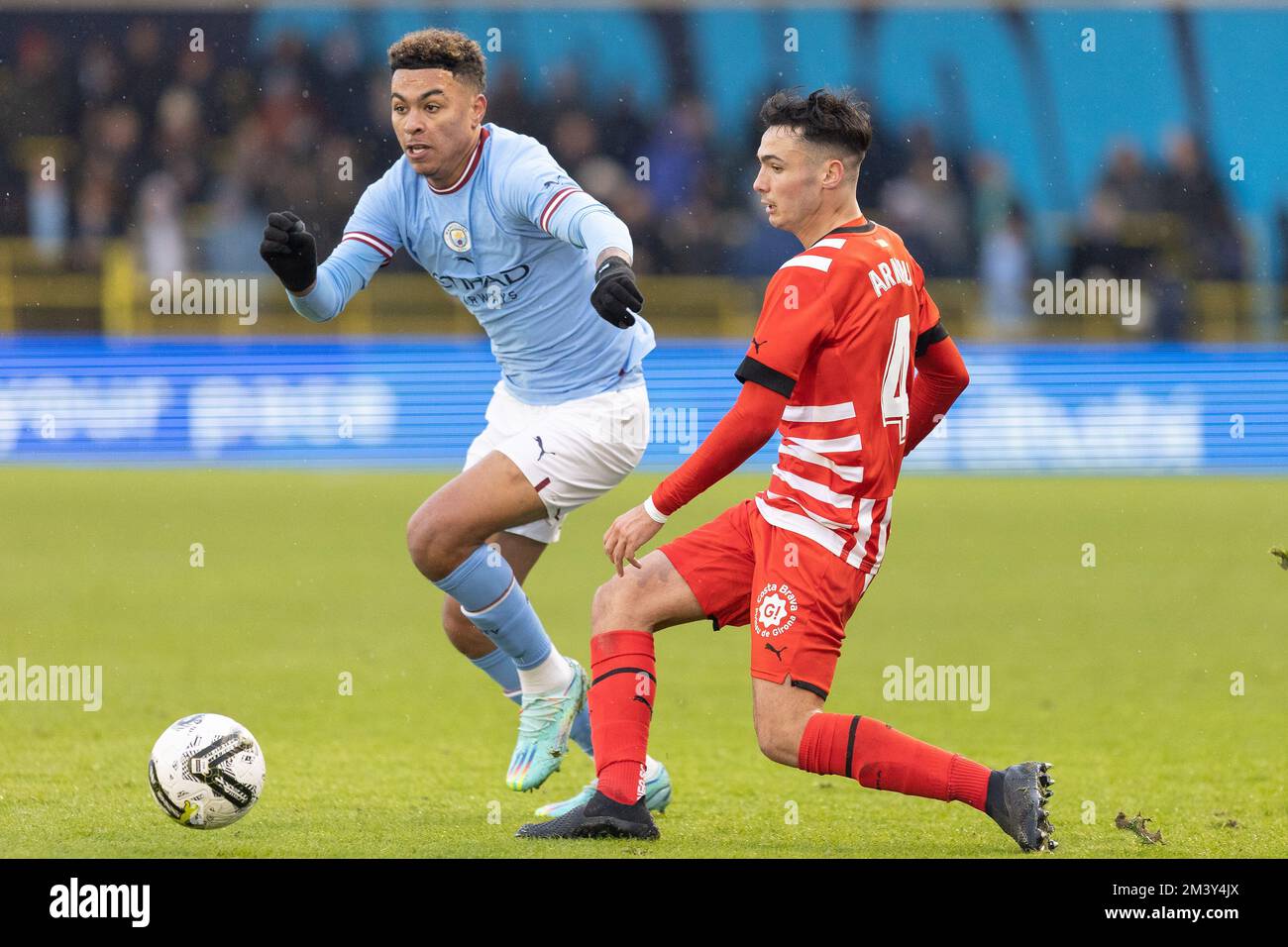 Morgan Rogers of Manchester City pressures Arnau Martinez #4 of Girona during the Mid season friendly match Manchester City vs Girona at Etihad Campus, Manchester, United Kingdom, 17th December 2022  (Photo by Phil Bryan/News Images) Stock Photo