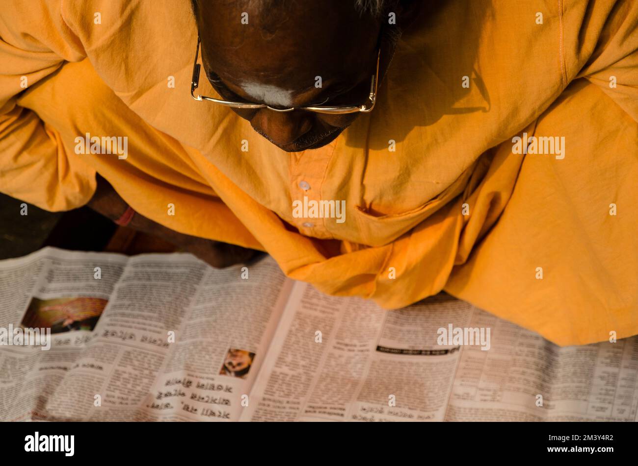 A man is reading a newspaper Stock Photo