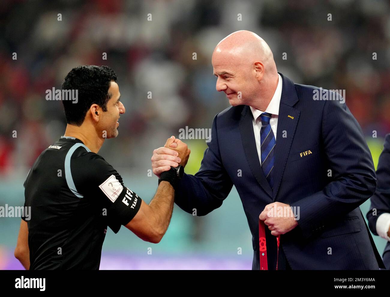 FIFA President Gianni Infantino shakes hands with referee Abdulrahman Al-Jassim as he presents him with a medal at the end of the FIFA World Cup third place play-off match at the Khalifa International Stadium, Doha. Picture date: Saturday December 17, 2022. Stock Photo