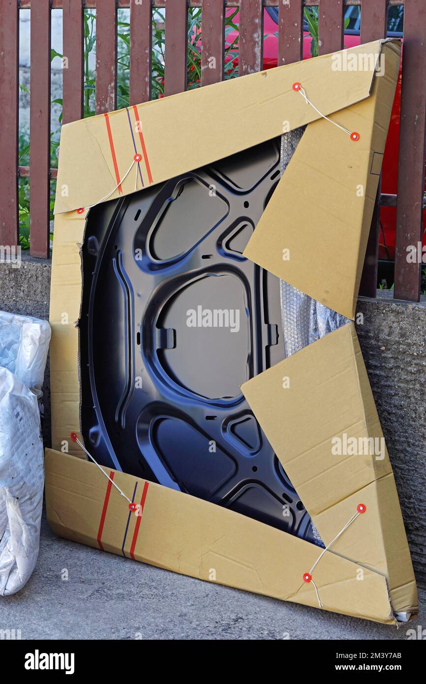 New hood car parts deliver in cardboard box packad Stock Photo Alamy