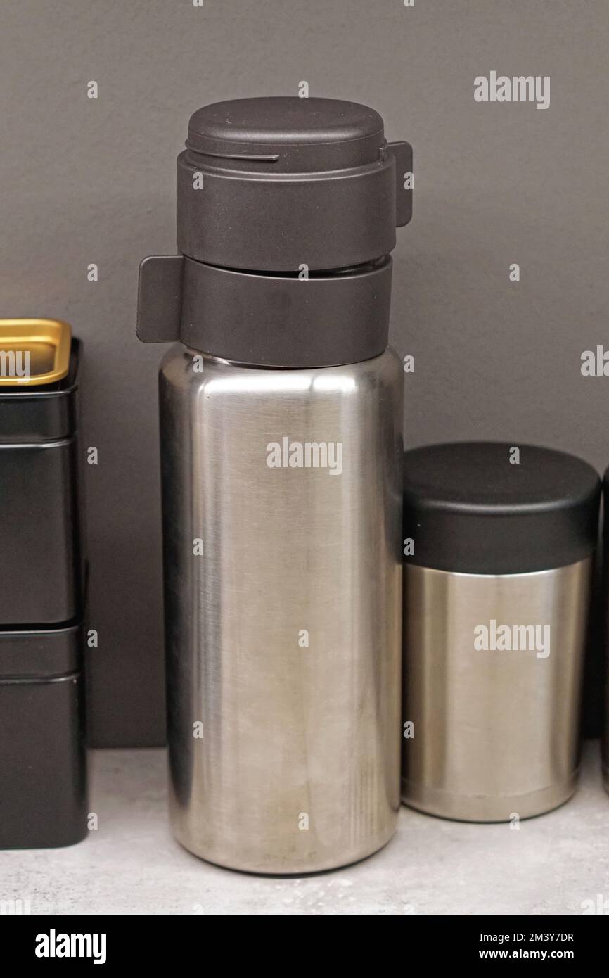 Insulated stainless steel vacuum bottle with cups reuse Stock Photo Alamy
