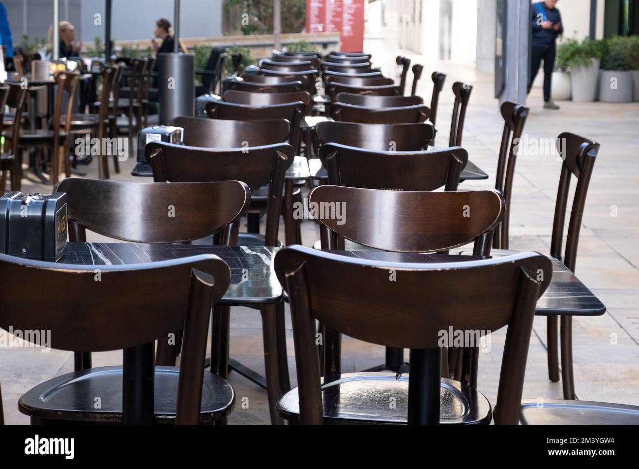 Empty table chairs in front of a restaurant. Stock Photo