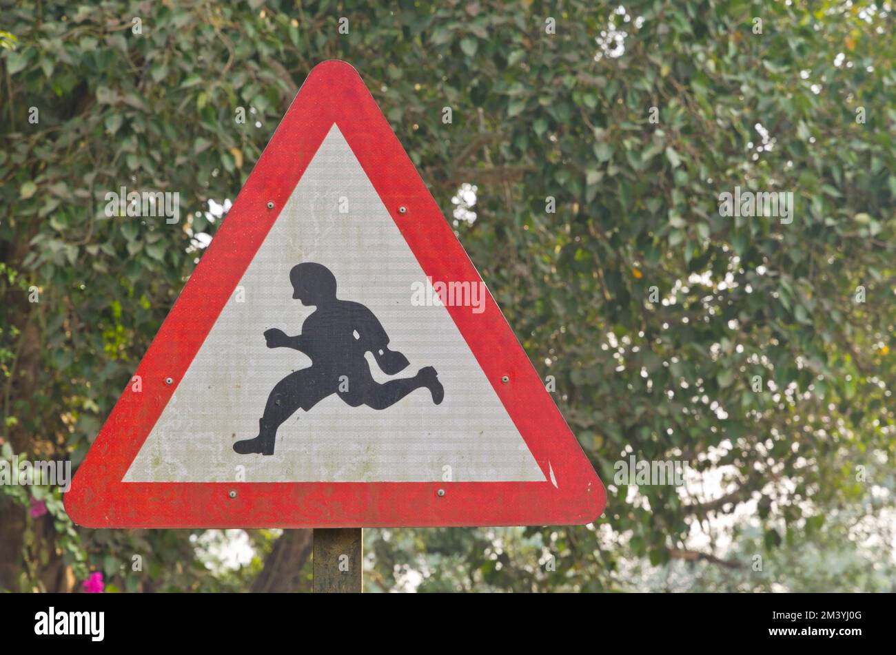 Traffic sign showing a running person, advice how to cross the road Stock Photo