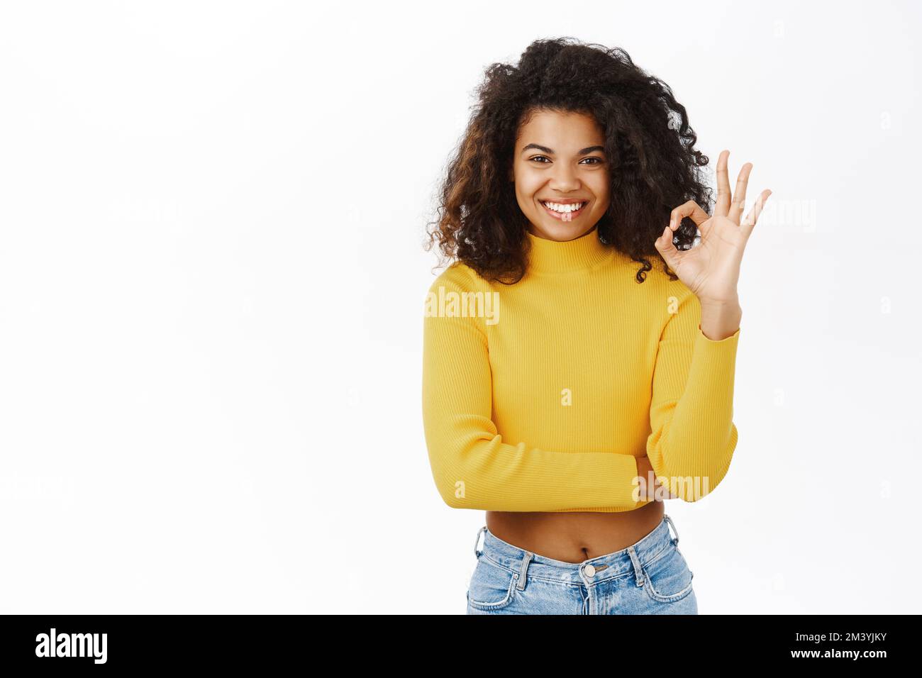 Okay, perfect. Smiling beautiful african american girl, showing ok ...