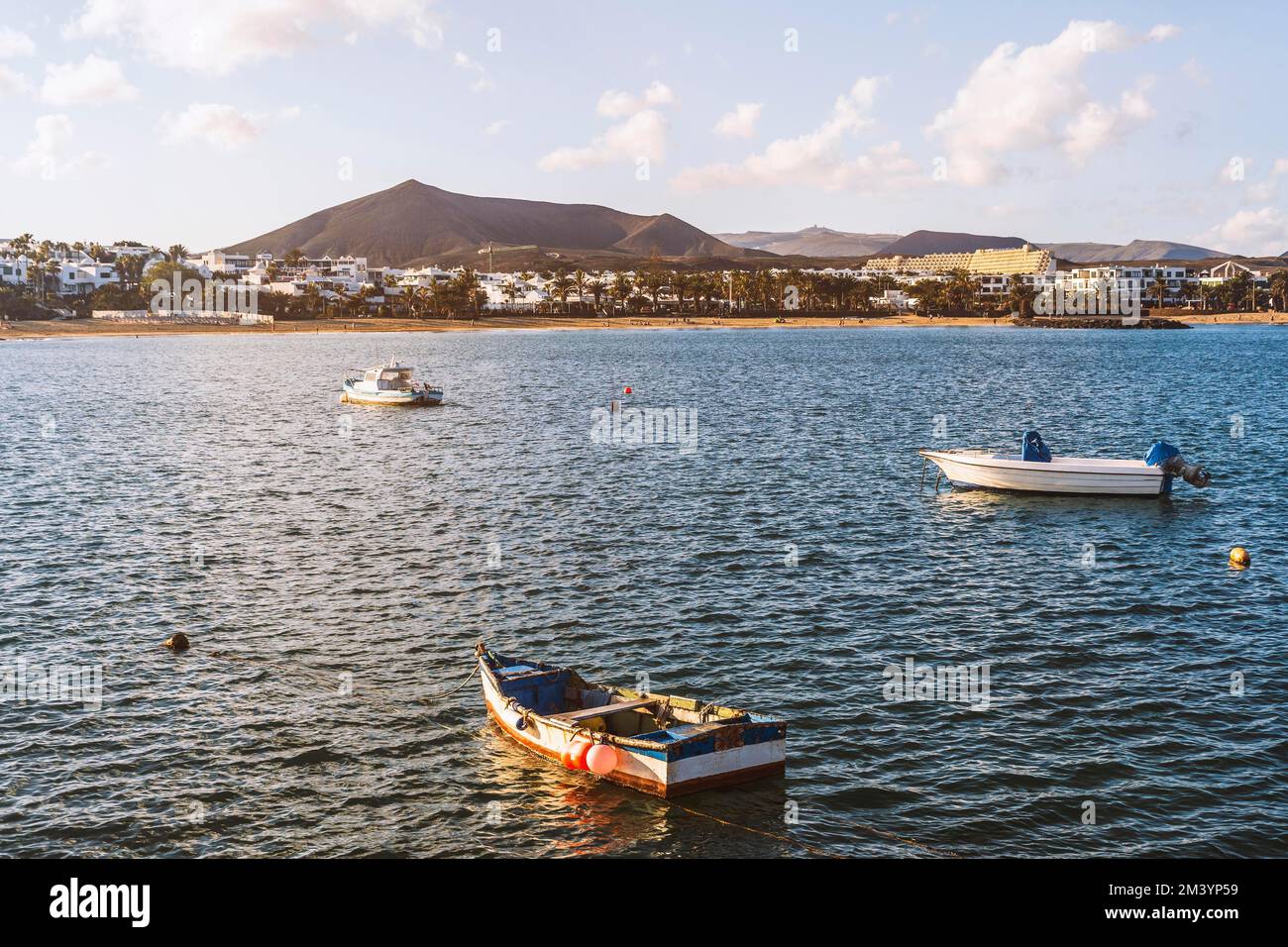 View of the resort town named Costa Teguise with boats on the foreground, Lanzarote, Canary Island, Spain Stock Photo