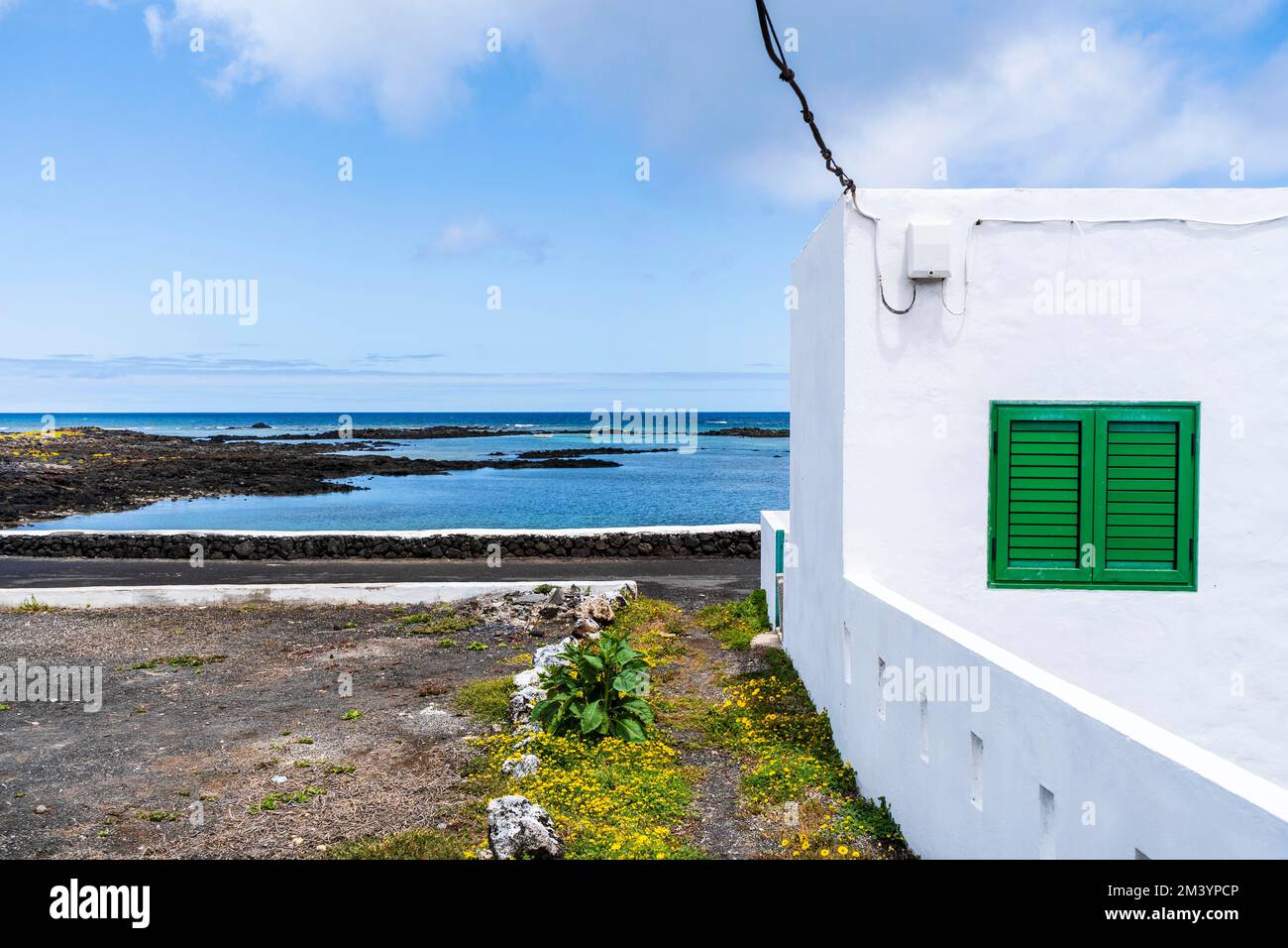 white building and blue ocean in Corralejo, Lanzarote, Canary Islands, Spain Stock Photo