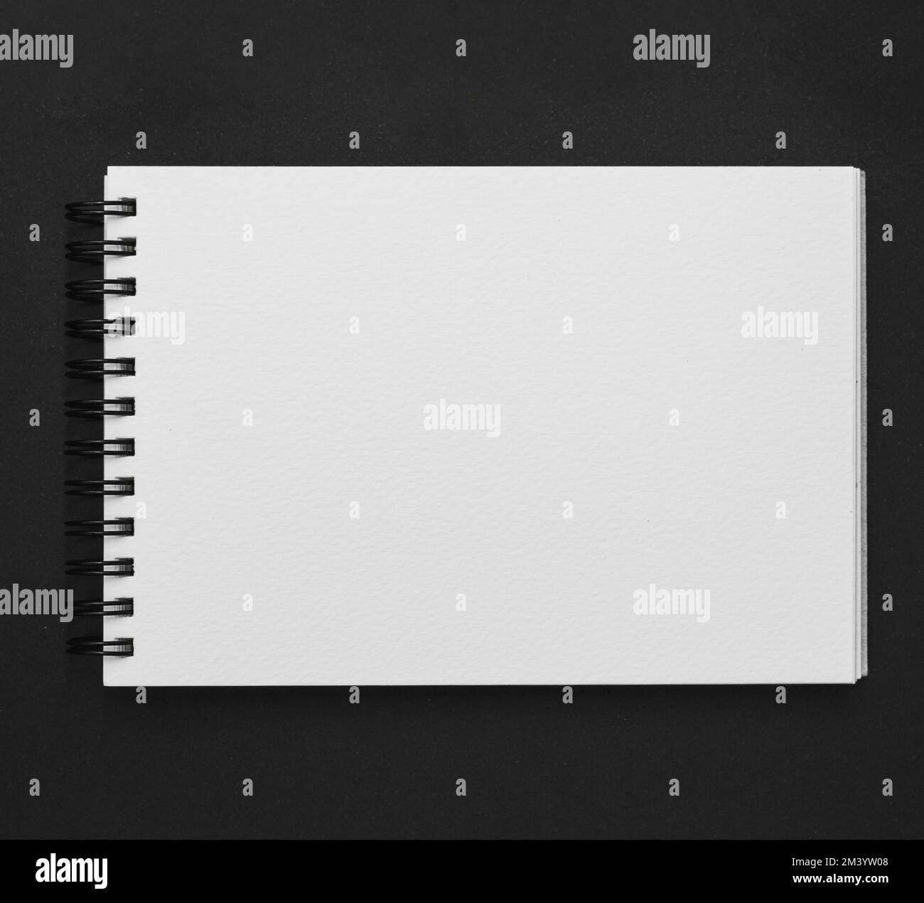 Elevated view spiral notepad black background Stock Photo Alamy