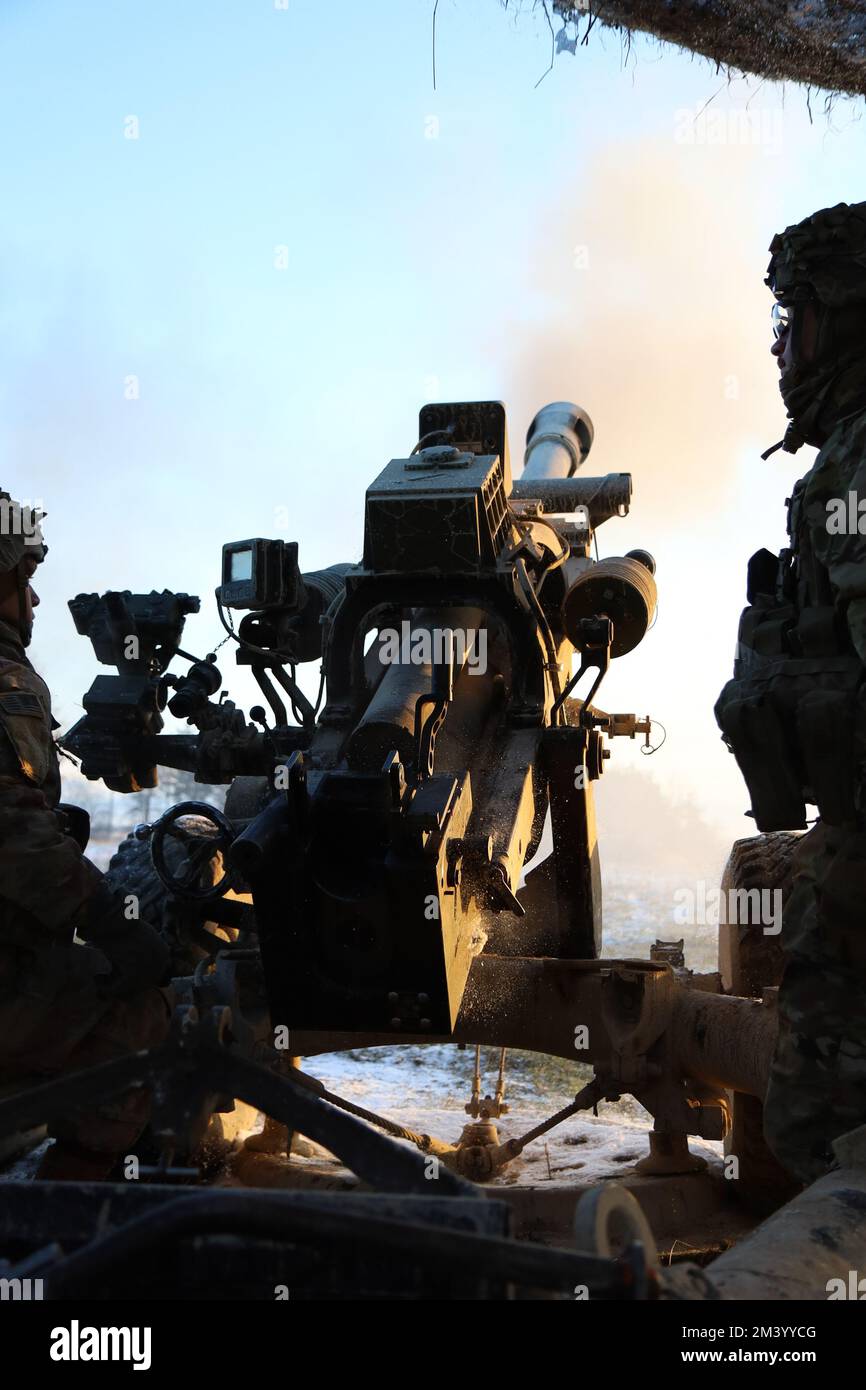 1-320 Field Artillery Regiment, 2nd Brigade Combat Team “STRIKE”, 101st Airborne Division (Air Assault) conducts live fires with M119 and M777 howitzers in support of the brigade combined arms maneuver live fire exercise (CAMLFX) in Grafenwoehr Training Area, Germany on Dec. 11, 2022.  The United States’ commitment to defending NATO territory is ironclad and the United States will continue to bolster our posture to better defend our NATO Allies.  (U.S. Army photos by Maj. Brett Sullenger, 2nd Brigade Combat Team “STRIKE” Public Affairs Officer) Stock Photo