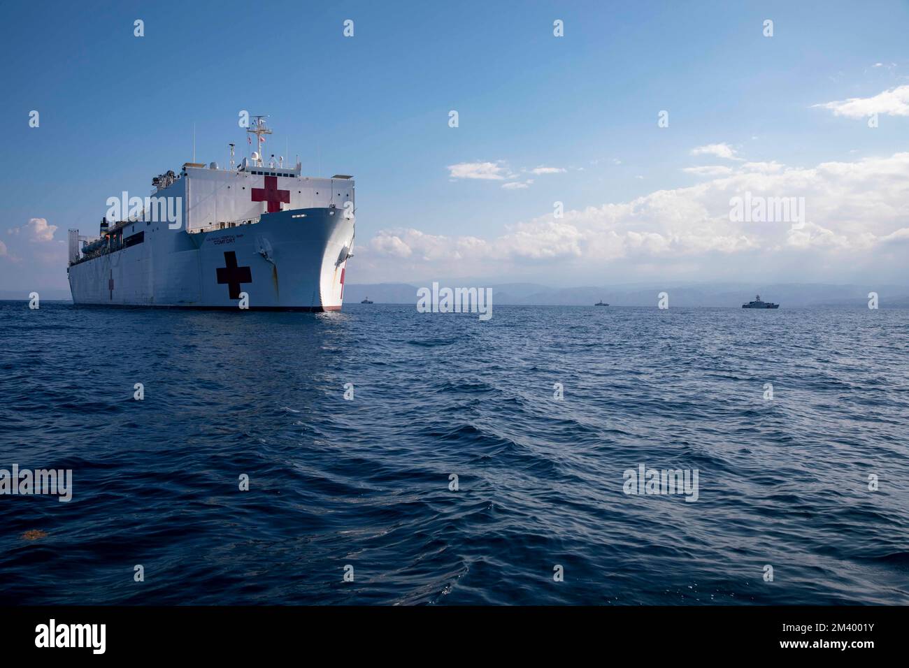 Hospital ship USNS Comfort (T-AH 20) and fast response cutters USCGC Rollin Fritch (WPC 1119), Kathleen Moore (WPC 1109), and Harold Miller (WPC 1138) steam together  as part of Continuing Promise 2022, Dec. 16, 2022. Comfort is deployed to U.S. 4th Fleet in support of Continuing Promise 2022, a humanitarian assistance and goodwill mission conducting direct medical care, expeditionary veterinary care, and subject matter expert exchanges with five partner nations in the Caribbean, Central and South America. (U.S. Navy photo by Mass Communication Specialist 2nd Class Ethan J. Soto) Stock Photo