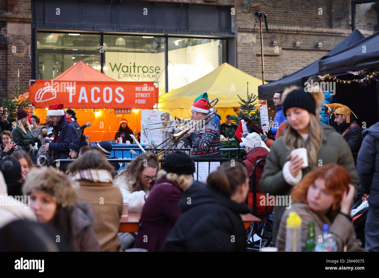 Local brass band playing Christmas music on Canopy Market at Kings Cross, north London, UK Stock