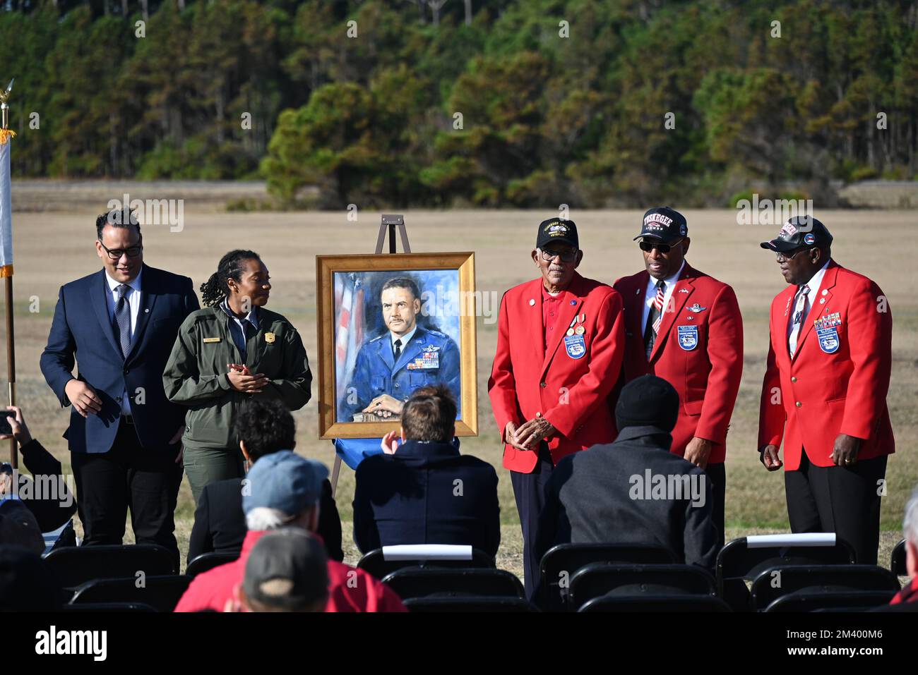 Kill Devil Hills, NC, USA, 17th December 2022, surviving members of the Tuskegee Airman pose with the portrait of General Benjamin O. Davis Jr. as he is inducted into the First Flight Shrine at the 119th anniversary of the Wright Brothers first powered flight. Credit D Guest Smith / Alamy Live News Stock Photo