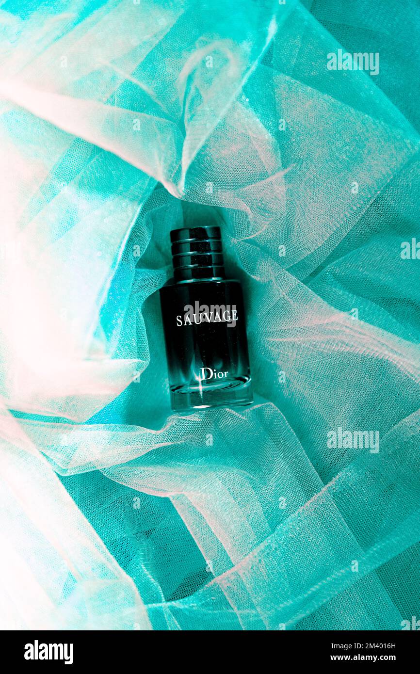 A vertical flat lay of Dior Sauvage Cologne against the teal fabric Stock  Photo - Alamy