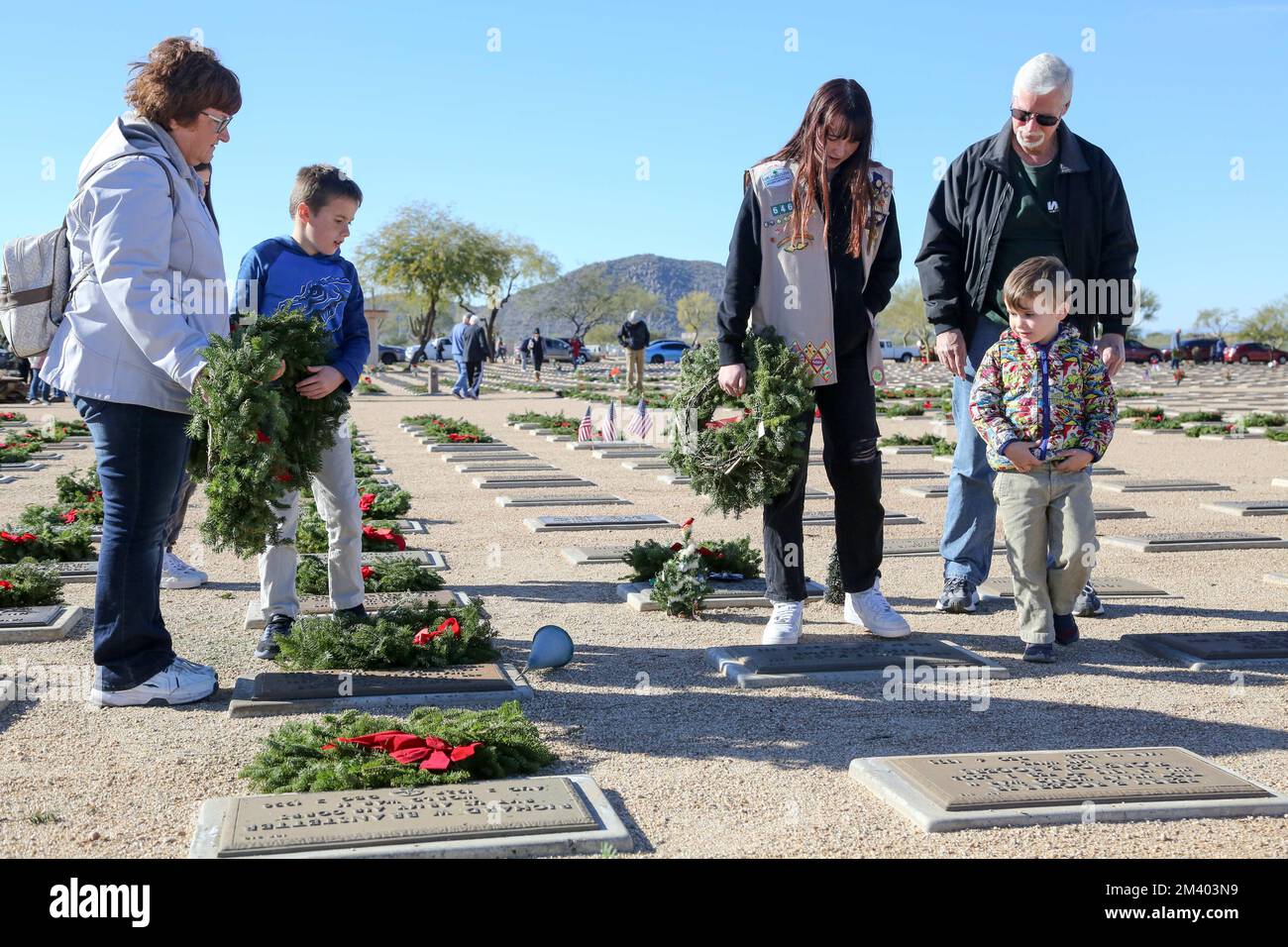 Family members and friends of veterans lay wreaths at the annual ...