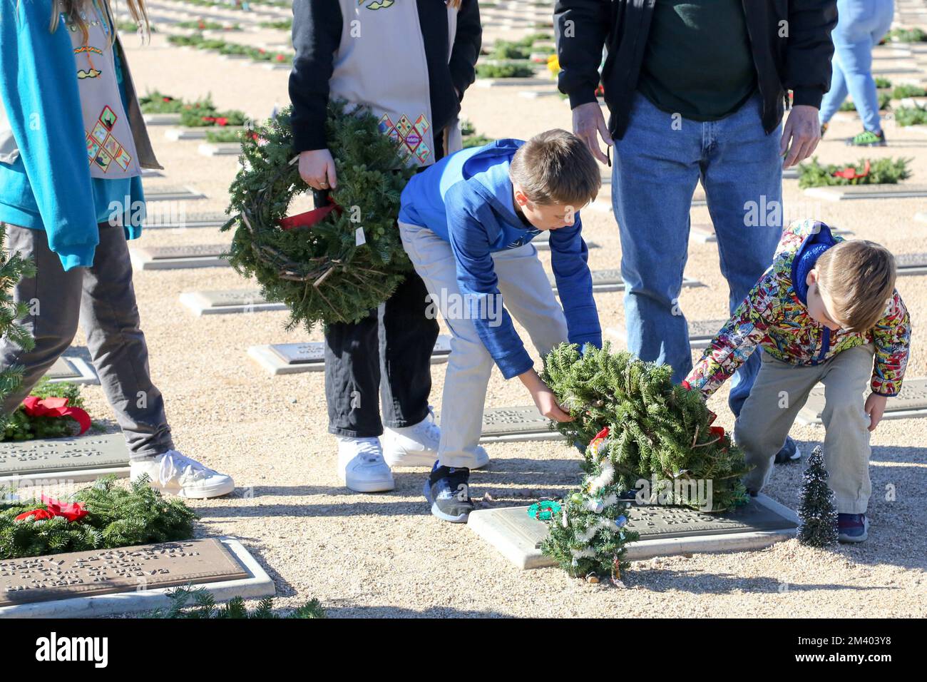Family members and friends of veterans lay wreaths at the annual ...