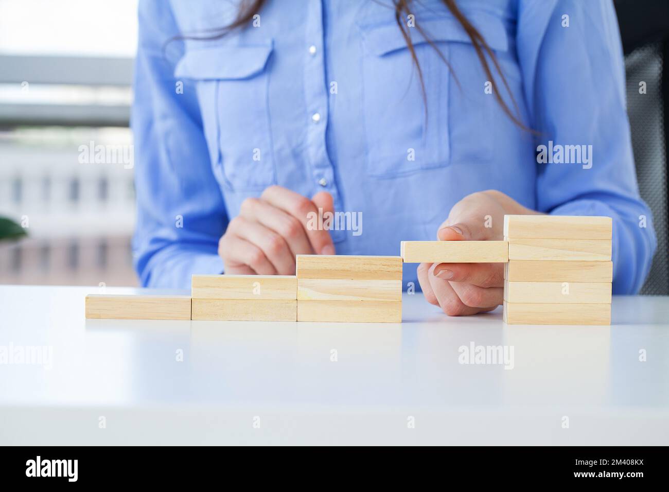 Woman hand arranging wood cube stacking as stair step shape Stock Photo ...