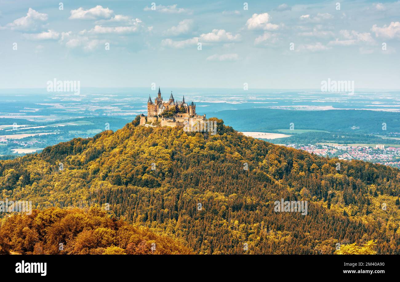Hohenzollern Castle on mountain top in autumn, Germany. View of German castle in forest, landmark of Stuttgart vicinity. Landscape of Swabian Alps in Stock Photo