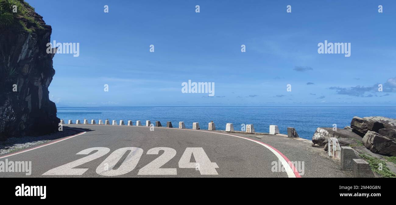 The New year 2024 road to future ahead word on asphalt road Stock Photo