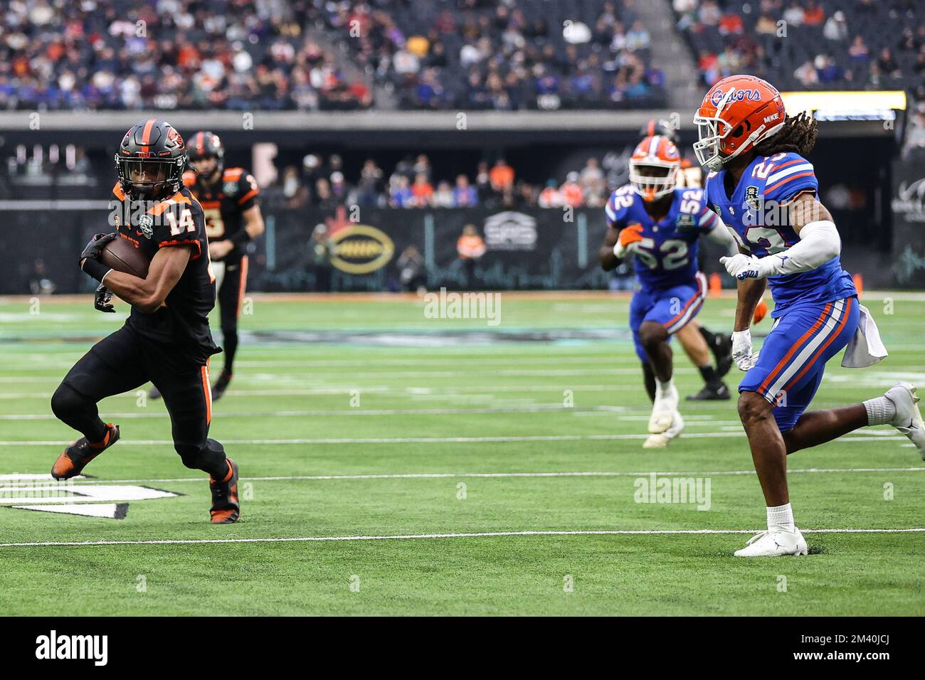 Las Vegas, NV, USA. 17th Dec, 2022. Oregon State Beavers wide receiver John Dunmore (14) tries to evade Florida Gators cornerback Jaydon Hill (23) during the first half of the SRS Distribution Las Vegas Bowl featuring the Florida Gators and the Oregon State Beavers at Allegiant Stadium in Las Vegas, NV. Christopher Trim/CSM/Alamy Live News Stock Photo